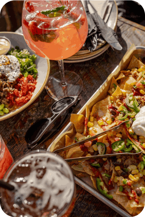 A Table Topped With Plates Of Food And Drinks